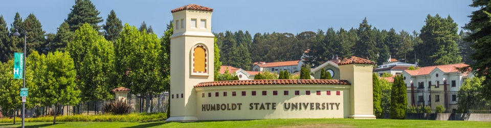 View of campus with sign reading "Cal Poly Humboldt" 