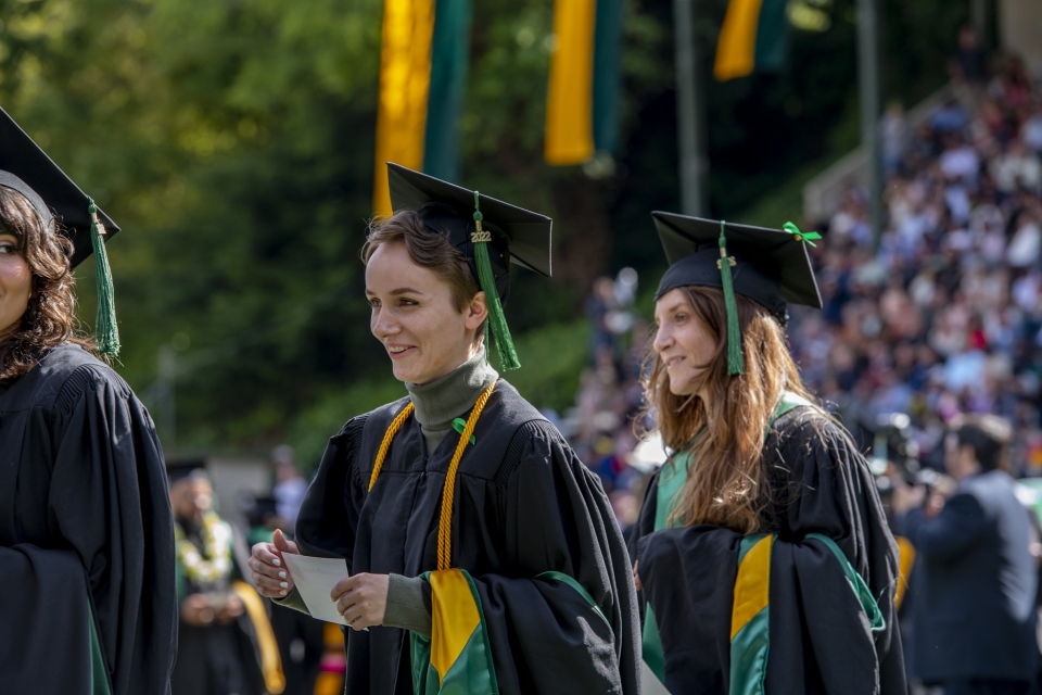 graduate students in line at commecement waiting to recieve diplomas