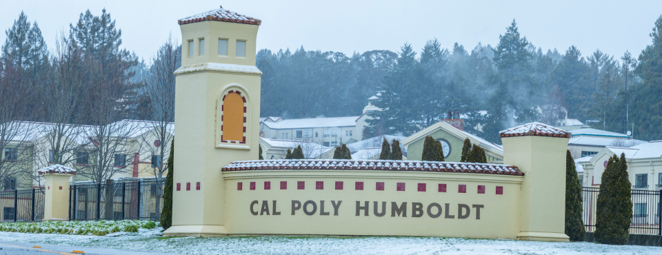 the Cal Poly Humboldt entrance sign covered in snow